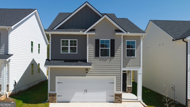 11893 Aukerman Way, Hampton, GA 30228 - craftsman inspired home with board and batten siding, an attached garage, concrete driveway, and a shingled roof