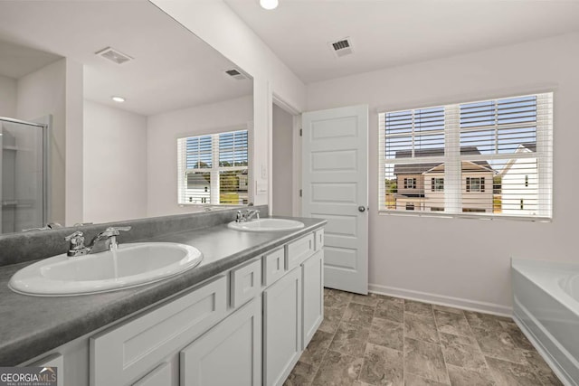 11893 Aukerman Way, Hampton, GA 30228 - full bathroom with double vanity, a garden tub, an enclosed shower, stone finish floors, and recessed lighting
