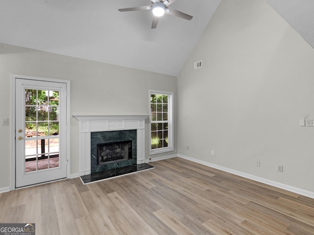 404 Northwind Pl, Stockbridge, GA 30281 - unfurnished living room featuring high vaulted ceiling, a ceiling fan, wood finished floors, a premium fireplace, and plenty of natural light