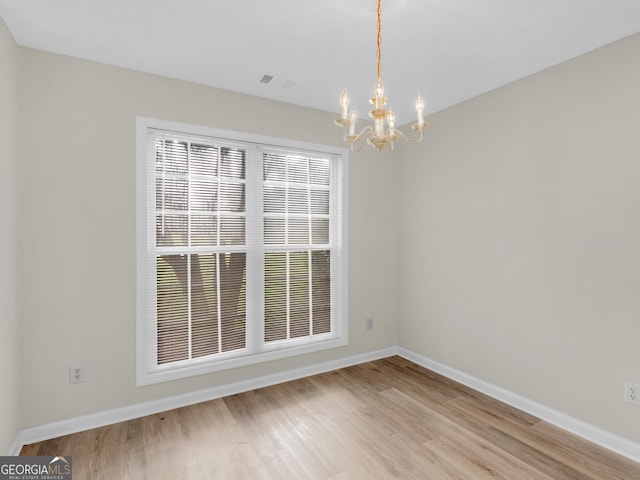 404 Northwind Pl, Stockbridge, GA 30281 - empty room with a chandelier and light wood-type flooring