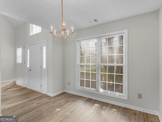 404 Northwind Pl, Stockbridge, GA 30281 - foyer entrance featuring a chandelier, light wood finished floors, and lofted ceiling