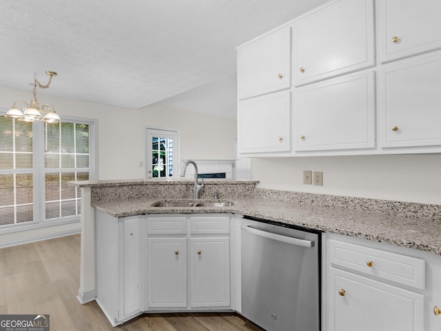 404 Northwind Pl, Stockbridge, GA 30281 - kitchen featuring dishwasher, light wood finished floors, a peninsula, white cabinetry, and a textured ceiling