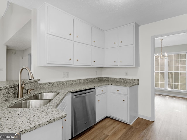 404 Northwind Pl, Stockbridge, GA 30281 - kitchen featuring stainless steel dishwasher, wood finished floors, white cabinets, and a chandelier