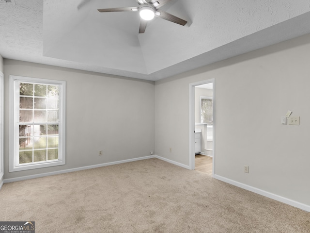 404 Northwind Pl, Stockbridge, GA 30281 - spare room featuring carpet flooring, ceiling fan, a textured ceiling, and a tray ceiling