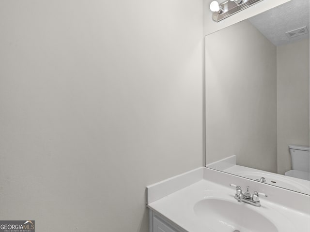 404 Northwind Pl, Stockbridge, GA 30281 - bathroom featuring vanity and a textured ceiling