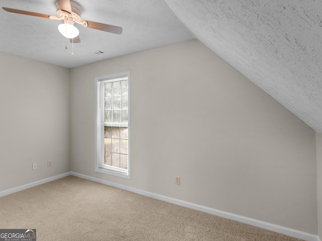 404 Northwind Pl, Stockbridge, GA 30281 - bonus room with a textured ceiling, carpet floors, ceiling fan, and lofted ceiling