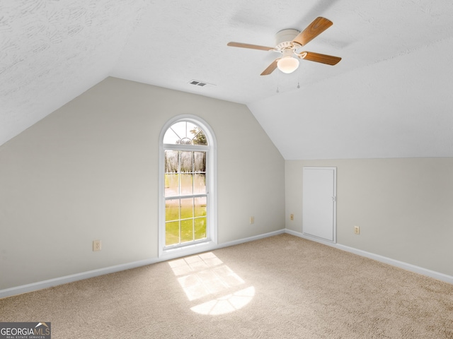 404 Northwind Pl, Stockbridge, GA 30281 - additional living space featuring lofted ceiling, carpet floors, a ceiling fan, and a textured ceiling
