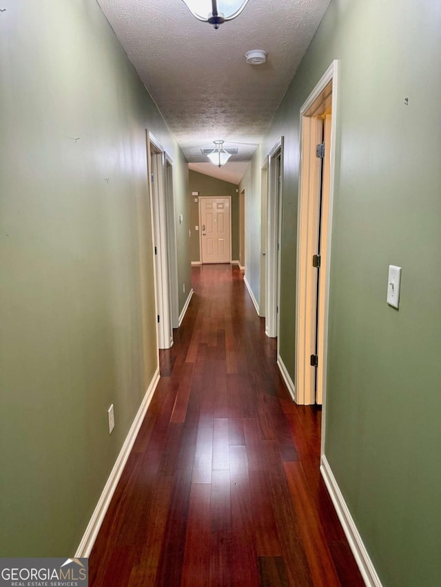 1013 Navaho Trl, Monroe, GA 30655 - hallway featuring a textured ceiling and dark wood-type flooring