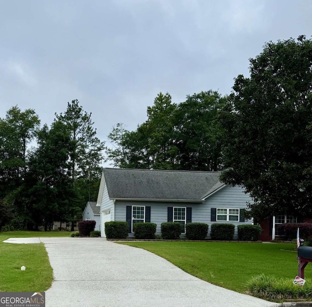 1013 Navaho Trl, Monroe, GA 30655 - view of front of property featuring driveway, a front lawn, and a shingled roof