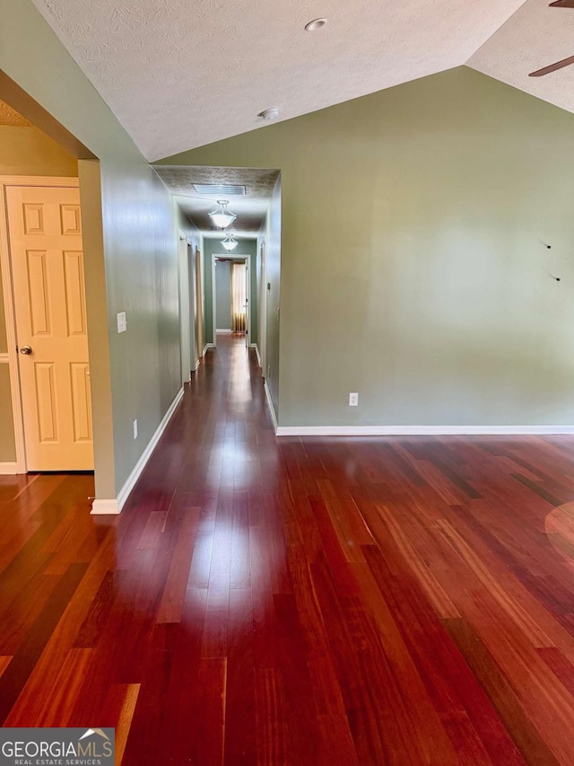 1013 Navaho Trl, Monroe, GA 30655 - hallway with lofted ceiling, wood finished floors, and a textured ceiling