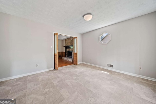 58 6th Ave W, Dallas, GA 30157 - empty room with a stone fireplace and a textured ceiling