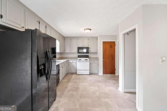 58 6th Ave W, Dallas, GA 30157 - kitchen with black appliances, light countertops, a textured ceiling, and arched walkways