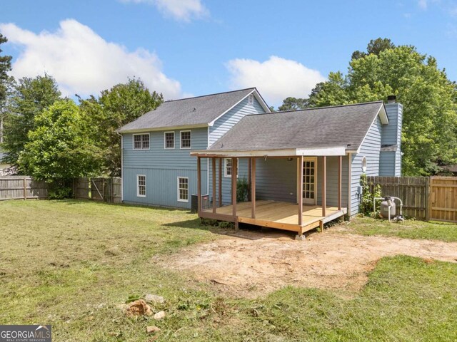 58 6th Ave W, Dallas, GA 30157 - rear view of house with a chimney, a fenced backyard, a deck, and a shingled roof