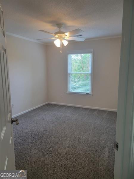 13565 Weycroft Cir, Alpharetta, GA 30004 - unfurnished room featuring ornamental molding, dark colored carpet, and a ceiling fan