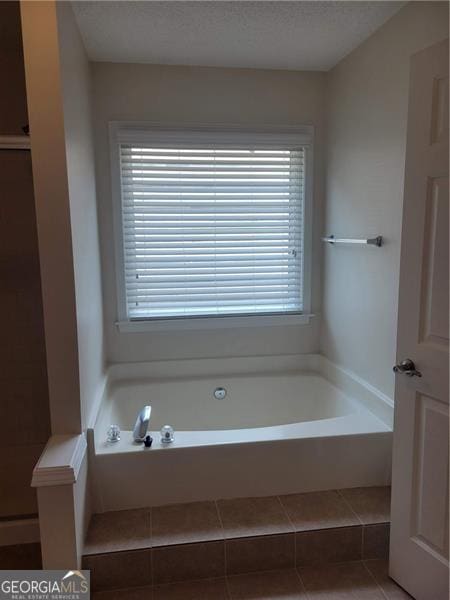 13565 Weycroft Cir, Alpharetta, GA 30004 - bathroom with healthy amount of natural light, a bath, and tile patterned flooring