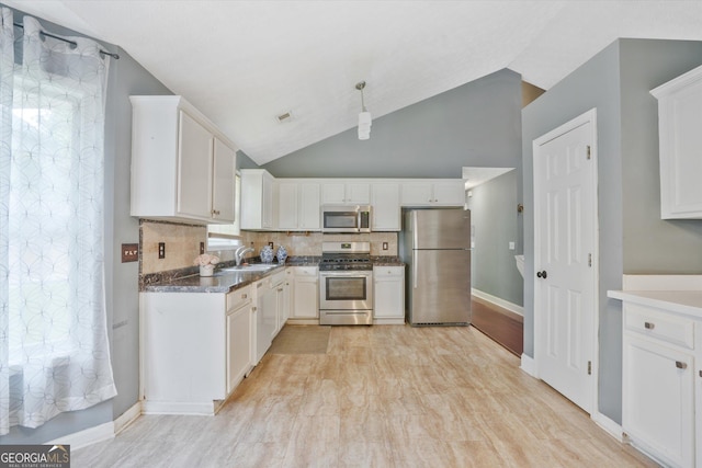 375 Shadetree Ln, Lawrenceville, GA 30044 - kitchen featuring stainless steel appliances, white cabinetry, decorative backsplash, dark countertops, and light wood-style flooring
