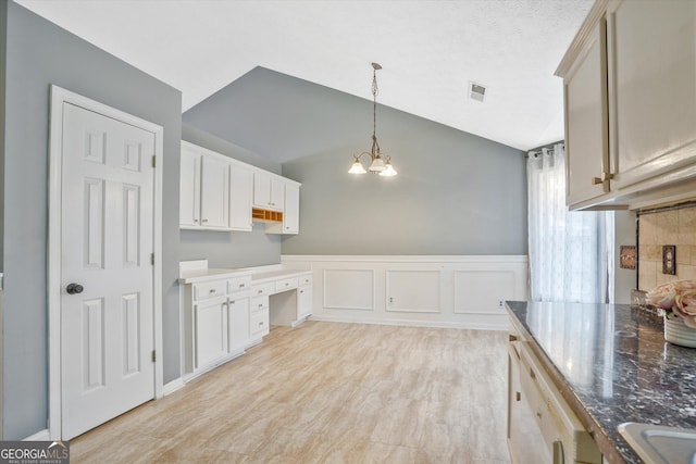 375 Shadetree Ln, Lawrenceville, GA 30044 - kitchen with a chandelier, decorative light fixtures, vaulted ceiling, wainscoting, and light wood finished floors
