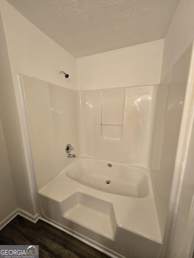 2985 Garnet Way S, Fulton, GA 30349 - full bath with wood finished floors, a textured ceiling, and a shower