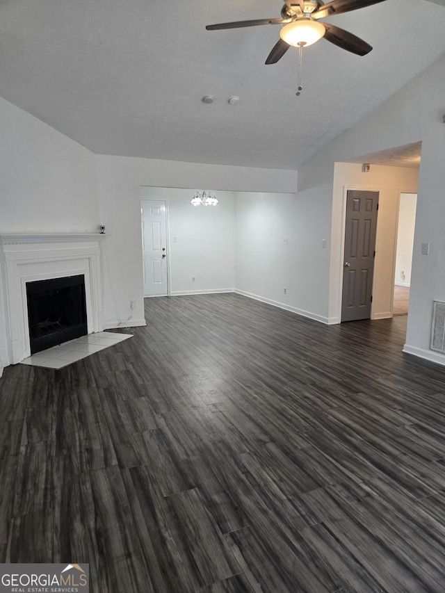 2985 Garnet Way S, Fulton, GA 30349 - unfurnished living room featuring ceiling fan, a fireplace, dark wood finished floors, lofted ceiling, and a chandelier