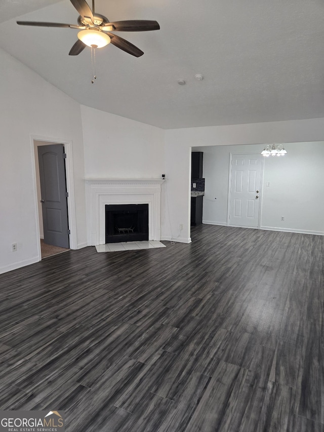 2985 Garnet Way S, Fulton, GA 30349 - unfurnished living room featuring a fireplace with flush hearth, a ceiling fan, dark wood-style flooring, lofted ceiling, and a chandelier