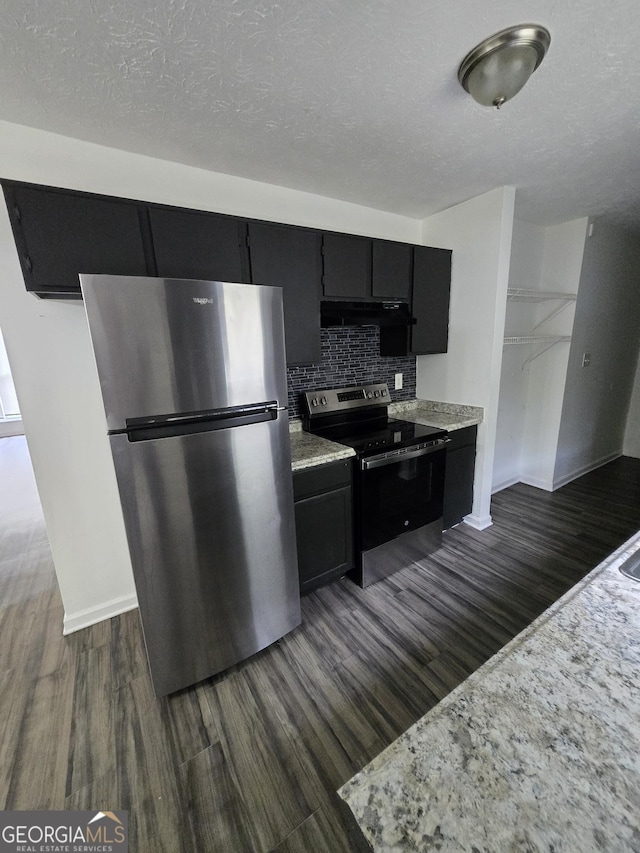 2985 Garnet Way S, Fulton, GA 30349 - kitchen featuring stainless steel appliances, dark cabinetry, dark wood-style floors, decorative backsplash, and a textured ceiling