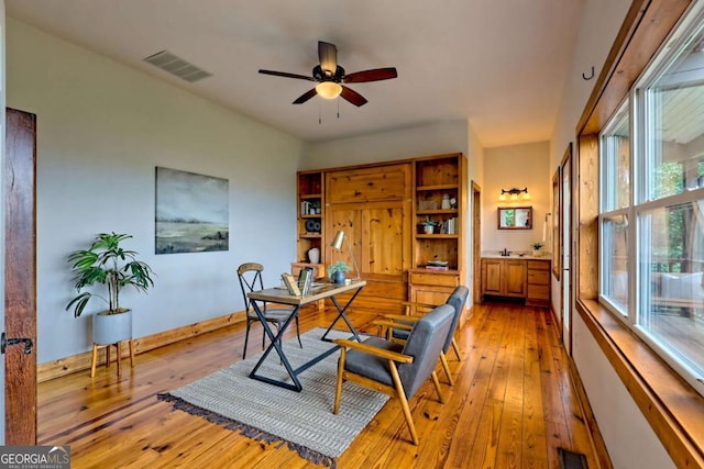 990 Hickory Nut Mountain Rd, Tallulah Falls, GA 30573 - home office with light wood-type flooring and a ceiling fan