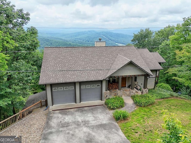 990 Hickory Nut Mountain Rd, Tallulah Falls, GA 30573 - view of front of home featuring a porch, a chimney, a shingled roof, driveway, and an attached garage
