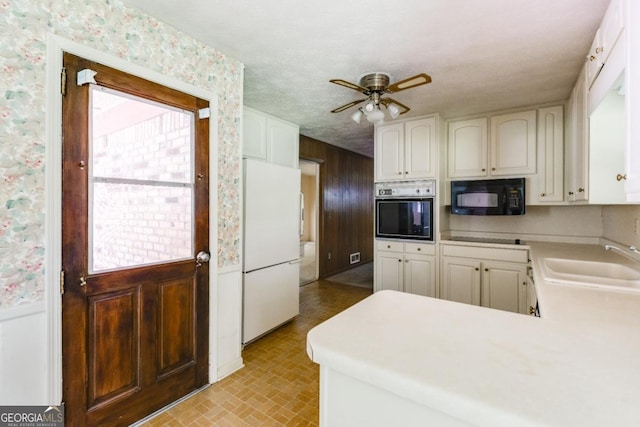 4714 Darlene Way, Tucker, GA 30084 - kitchen with black microwave, wall oven, freestanding refrigerator, brick patterned flooring, and light countertops