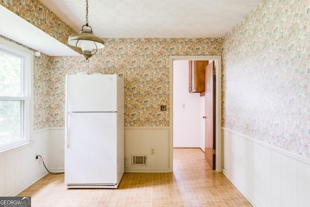 4714 Darlene Way, Tucker, GA 30084 - kitchen with freestanding refrigerator, wallpapered walls, and a wainscoted wall