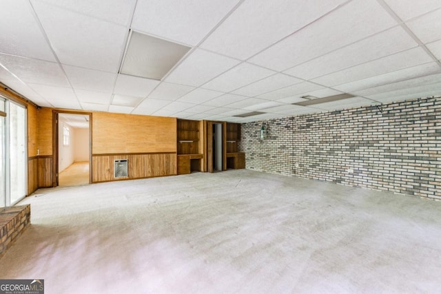 4714 Darlene Way, Tucker, GA 30084 - basement featuring wooden walls, a paneled ceiling, brick wall, and carpet