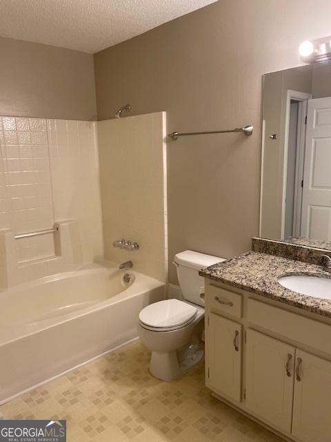 207 Oak Cir N, Stockbridge, GA 30281 - full bathroom with vanity, shower / tub combination, and a textured ceiling