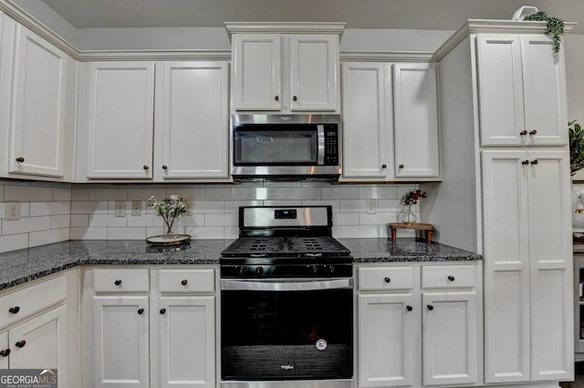 2410 Melton Common Dr, Dacula, GA 30019 - kitchen with stainless steel appliances, decorative backsplash, dark stone counters, and white cabinetry