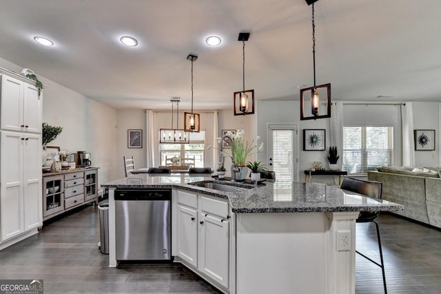 2410 Melton Common Dr, Dacula, GA 30019 - kitchen with stainless steel dishwasher, open floor plan, an island with sink, healthy amount of natural light, and recessed lighting