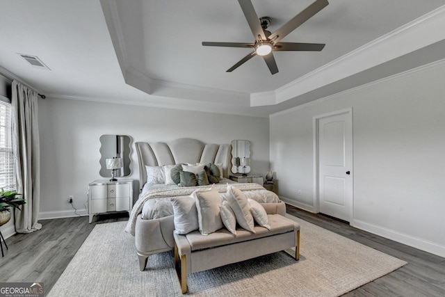 2410 Melton Common Dr, Dacula, GA 30019 - bedroom with a tray ceiling, ornamental molding, wood finished floors, and a ceiling fan
