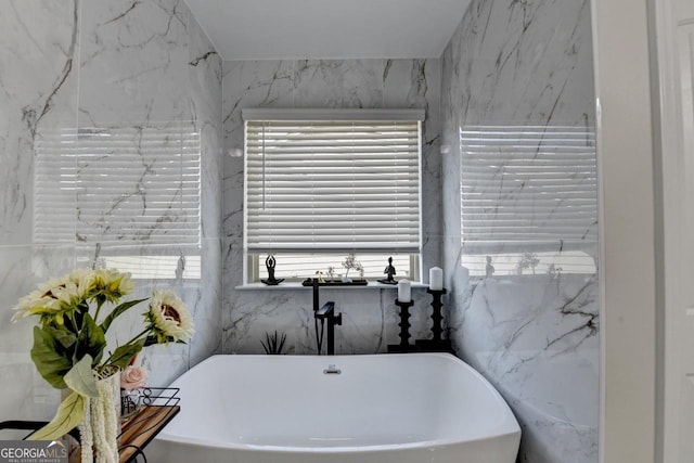 2410 Melton Common Dr, Dacula, GA 30019 - bathroom with a freestanding tub and tile walls