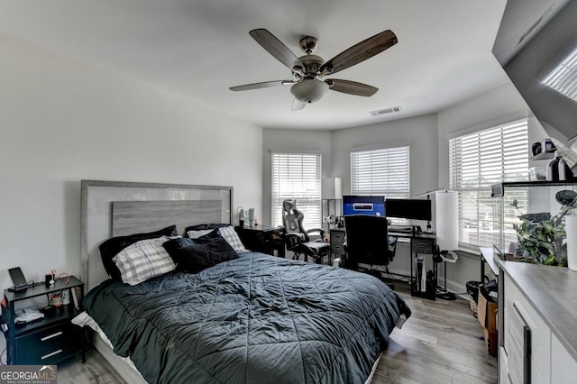 2410 Melton Common Dr, Dacula, GA 30019 - bedroom with light wood-style flooring, an office area, and a ceiling fan