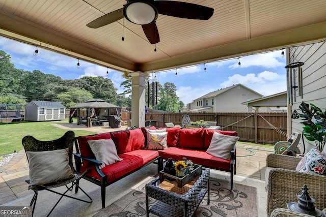 2410 Melton Common Dr, Dacula, GA 30019 - fenced backyard featuring a gazebo, an outdoor living space, a patio area, a shed, and ceiling fan