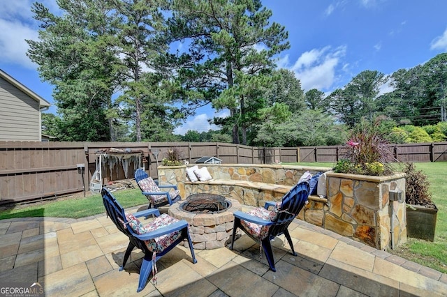 2410 Melton Common Dr, Dacula, GA 30019 - fenced backyard featuring a fire pit and a patio area