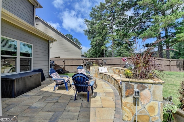 2410 Melton Common Dr, Dacula, GA 30019 - fenced backyard featuring a fire pit and a patio