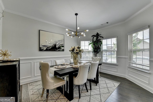 2410 Melton Common Dr, Dacula, GA 30019 - dining space featuring a chandelier, crown molding, a decorative wall, wainscoting, and wood finished floors