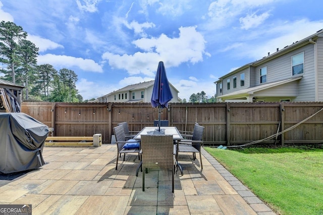 2410 Melton Common Dr, Dacula, GA 30019 - fenced backyard featuring a patio, grilling area, and outdoor dining space