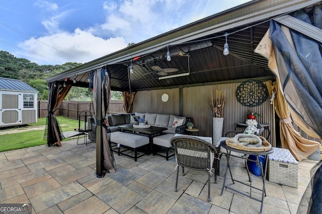 2410 Melton Common Dr, Dacula, GA 30019 - fenced backyard featuring a gazebo, a shed, a ceiling fan, a patio, and an outdoor hangout area