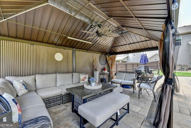2410 Melton Common Dr, Dacula, GA 30019 - fenced backyard featuring outdoor lounge area, a patio, a gazebo, and a ceiling fan