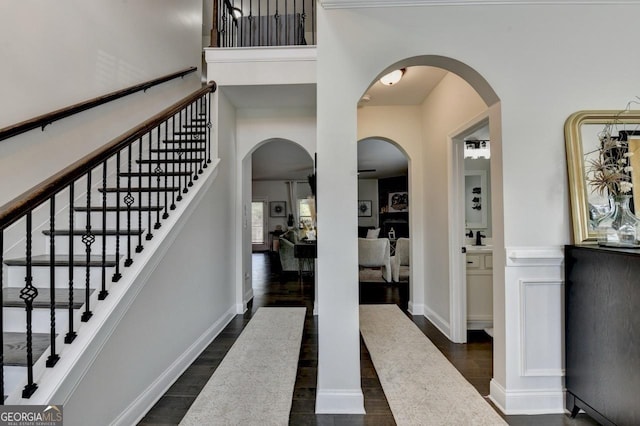 2410 Melton Common Dr, Dacula, GA 30019 - entrance foyer with dark wood-type flooring, stairs, and arched walkways