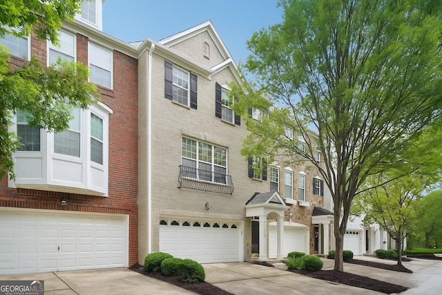 11302 Musette Cir, Alpharetta, GA 30009 - view of property with a garage, concrete driveway, and brick siding