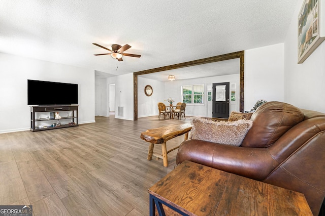 665 Center Of The World Rd, Canon, GA 30520 - living area featuring wood finished floors, a ceiling fan, and a textured ceiling