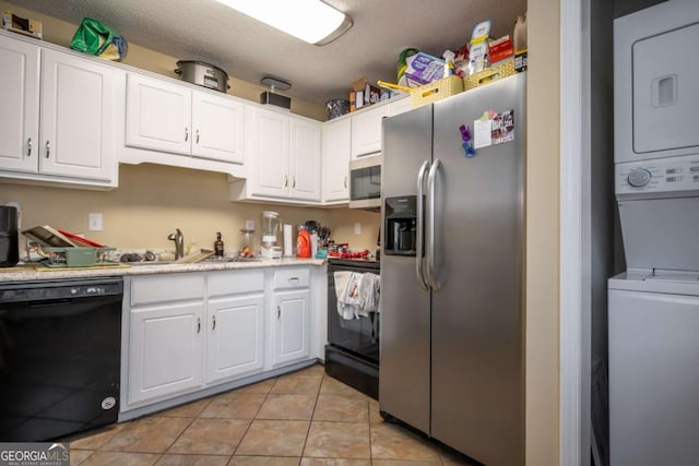 2165 Milledge Ave Unit F4, Athens, GA 30605 - kitchen featuring stainless steel appliances, estacked washer and dryer, white cabinetry, and light tile patterned floors