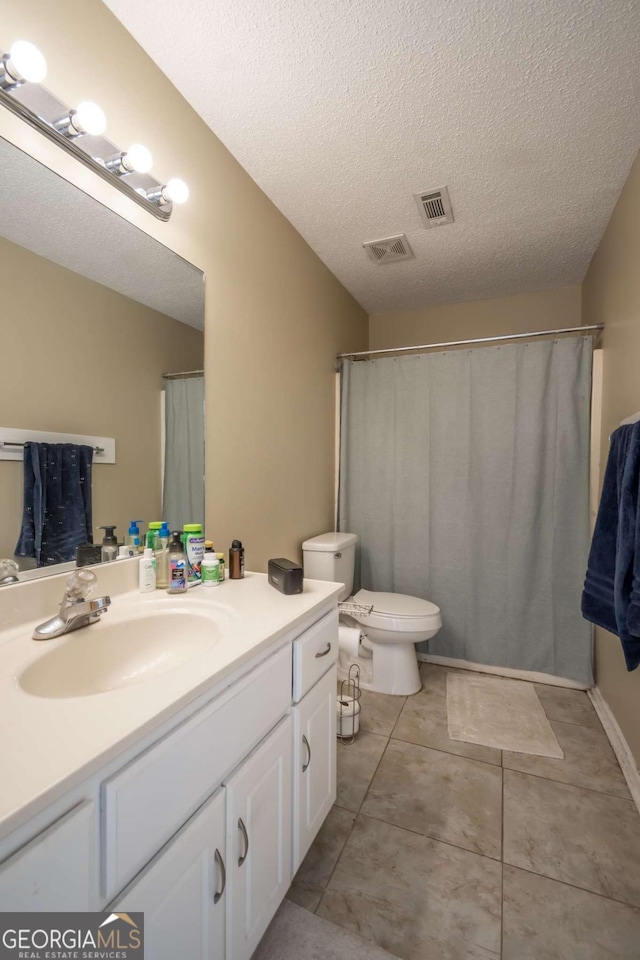 2165 Milledge Ave Unit F4, Athens, GA 30605 - bathroom with vanity, a textured ceiling, and tile patterned floors