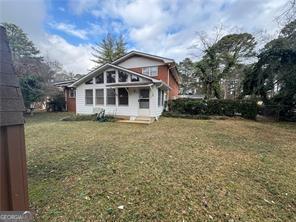 1046 Sans Souci Way, Clarkston, GA 30021 - rear view of property featuring a yard