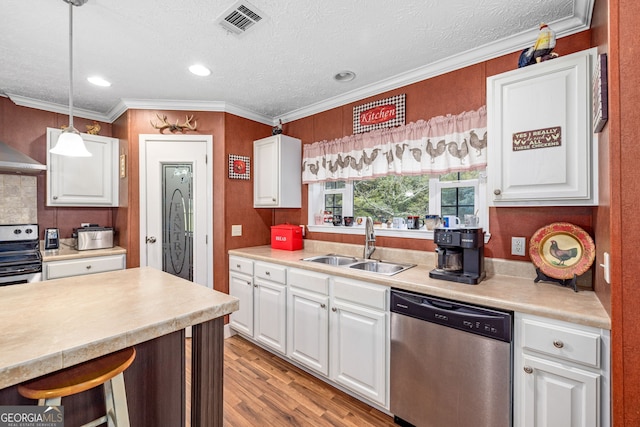 319 Aderhold Rd, Carnesville, GA 30521 - kitchen featuring appliances with stainless steel finishes, light countertops, white cabinetry, light wood-style flooring, and ornamental molding